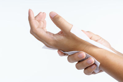 Close-up of human hand against white background