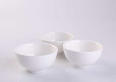 High angle view of empty bowls against white background