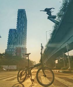 Bicycle on city against sky