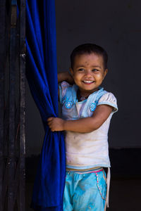 A child from a rural area looking happy even in a grubby condition. 