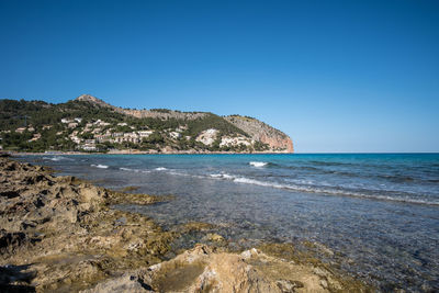 Scenic view of sea against clear blue sky