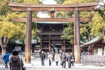 Group of people outside temple against building