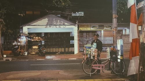 People riding bicycle on street in city