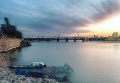 Scenic view of bay against sky at sunset