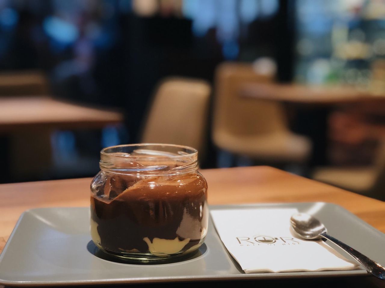 CLOSE-UP OF COFFEE IN GLASS ON TABLE