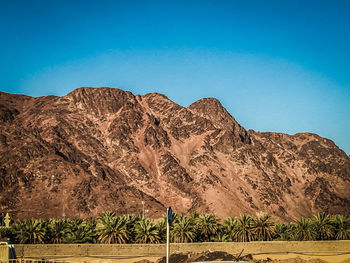 Scenic view of mountains against clear blue sky