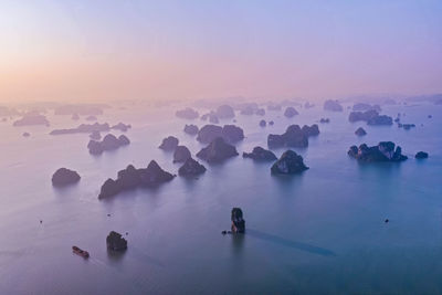 Aerial view of sea against sky during sunset