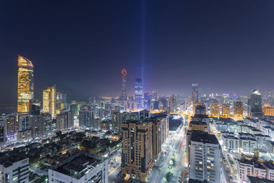 Illuminated cityscape against sky at night