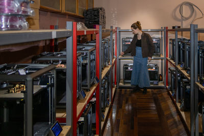 Rear view of woman standing in factory
