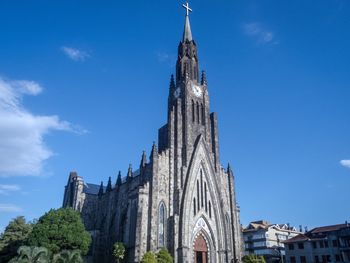 Low angle view of building against blue sky