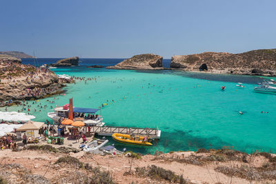 Scenic view of beach against clear blue sky