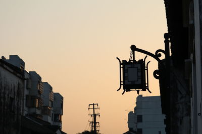 Silhouette of communications tower against sky