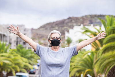 Portrait of senior woman wearing sunglasses standing outdoors