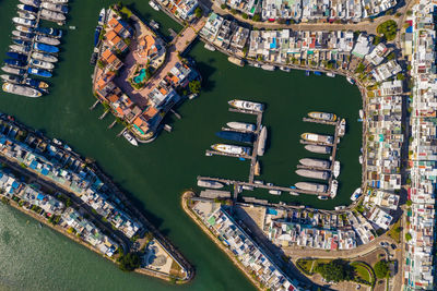 Aerial view of boats moored by cityscape