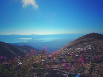 Scenic view of mountains against blue sky