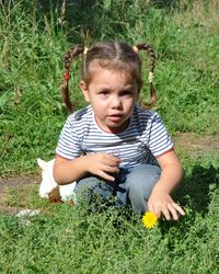 Cute girl sitting on grass