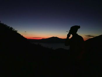 Silhouette of man against clear sky