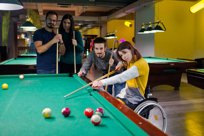 People playing with ball on table