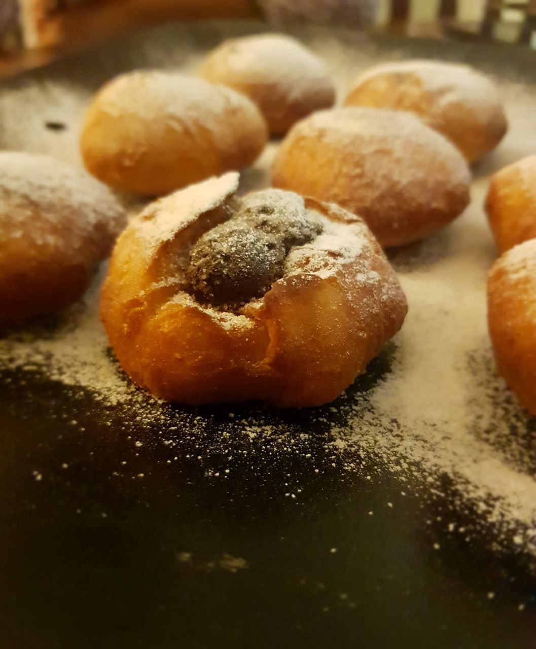 food, food and drink, freshness, beignet, dessert, baked, no people, powdered sugar, sweet food, indoors, close-up, cuisine, still life, store, selective focus, sweet, dish, bread, sugar, bakery, fast food, focus on foreground, table