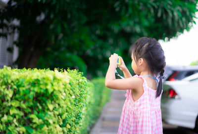 Cute girl holding plant