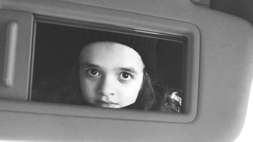 Portrait of girl looking through window