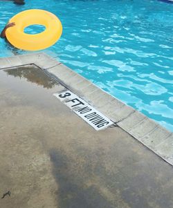 High angle view of text floating on swimming pool