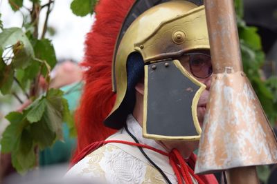 Close-up of thoughtful man wearing medieval costume against leaves