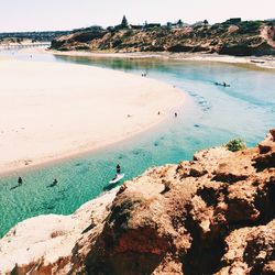 High angle view of rock formations by beach