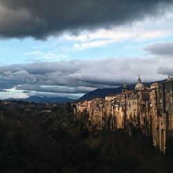 Scenic view of mountains against cloudy sky