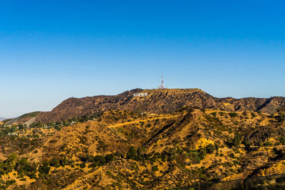 Scenic view of mountains against clear blue sky