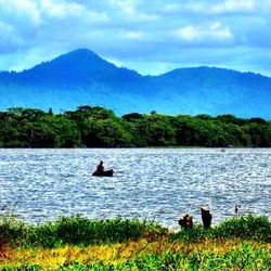 Scenic view of lake against cloudy sky