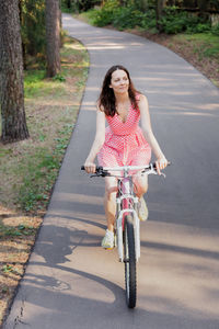 Portrait of young woman with bicycle