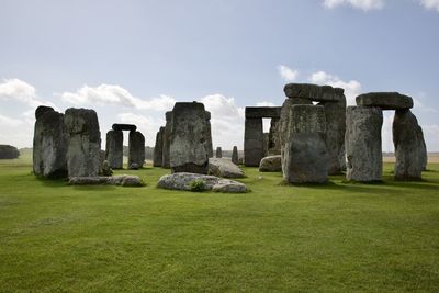 Stone circle on field against sky