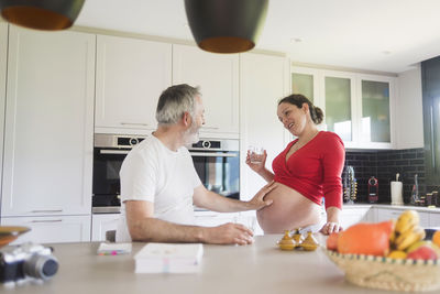 People standing by table at home