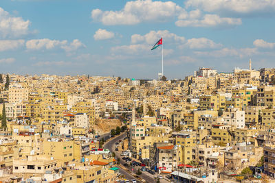 Jordan flag in amman, panoramic view of cloudy sky background