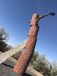 Low angle view of old tree against blue sky