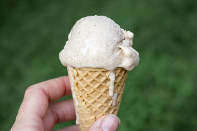 Close-up of hand holding ice cream cone