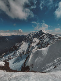 Scenic view of snowcapped mountains against sky