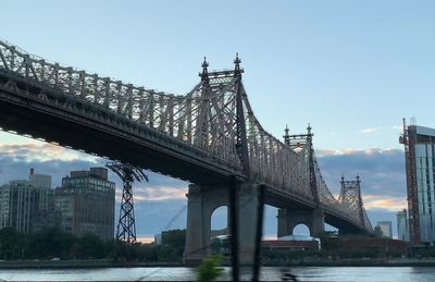 Bridge over river with city in background