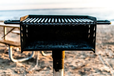 Close-up of old metallic structure on land