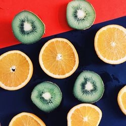 Directly above shot of halved limes and kiwis on table