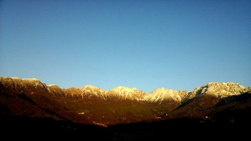 Scenic view of mountains against clear blue sky