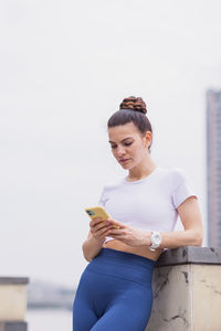 Side view of young man using mobile phone