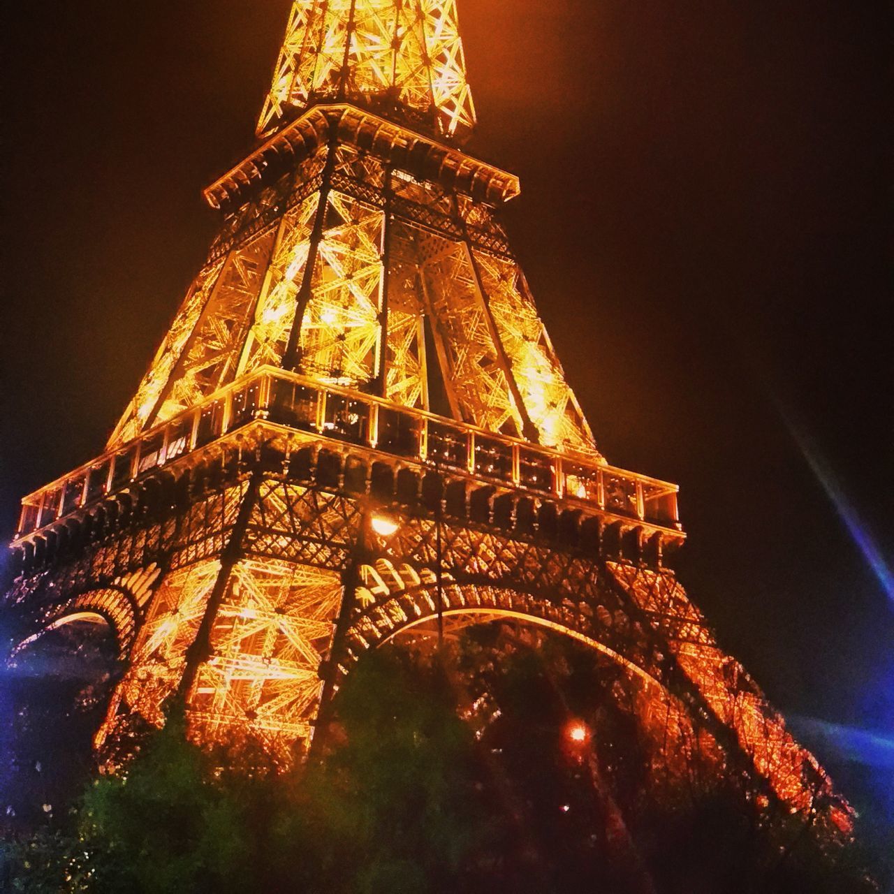 illuminated, famous place, night, architecture, international landmark, travel destinations, built structure, tourism, low angle view, capital cities, travel, city, sky, eiffel tower, building exterior, tower, architectural feature, tall - high, history, long exposure