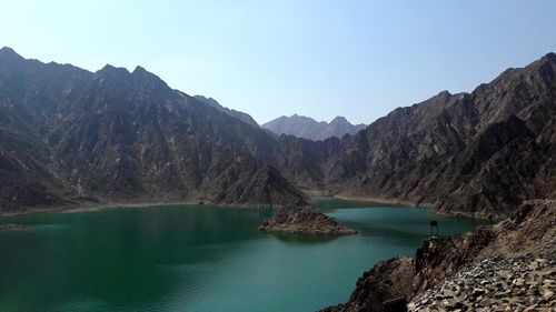 Scenic view of lake and mountains against clear sky