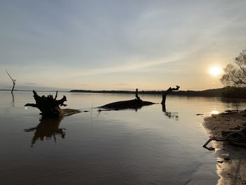 Scenic view of lake against sky during sunset