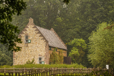 House amidst trees and buildings