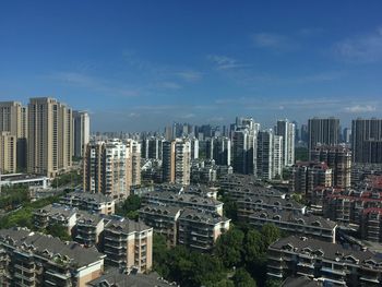 High angle view of modern buildings in city against sky