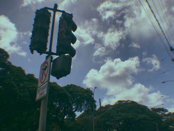 Low angle view of road sign against sky