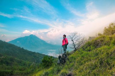 Man standing on mountain against sky